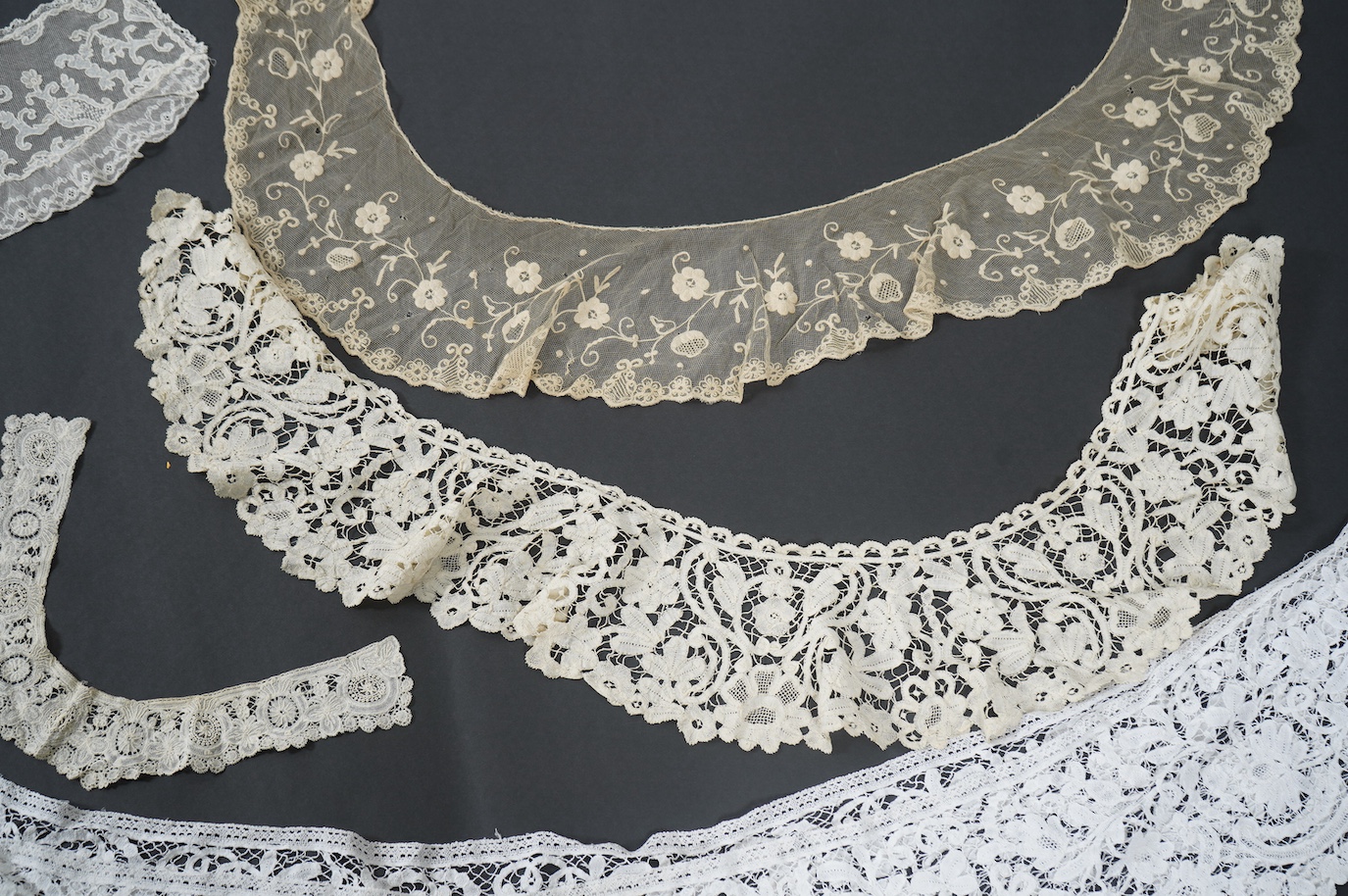 Seven late 19th century collars and trimming, being a long wide length of bobbin lace trimming - 268cm, two similar Bruges cream lace collars, an Irish Carrick-ma-cross collar, a fine needle run collar and another with a